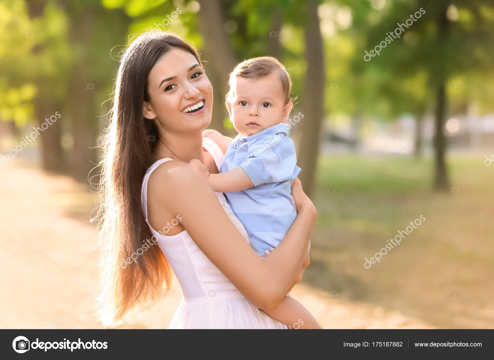 Beautiful young mother holding cute baby boy, outdoors Stock Photo ...