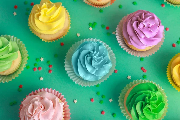 Tasty cupcakes on color background — Stock Photo, Image