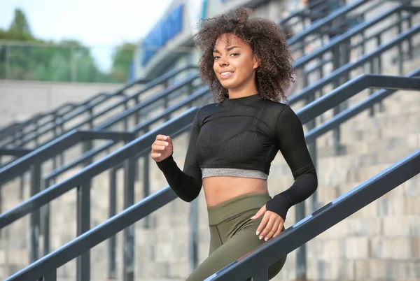 Sporty woman running outdoors — Stock Photo, Image