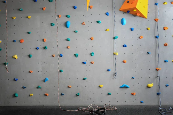 Grey wall with climbing holds