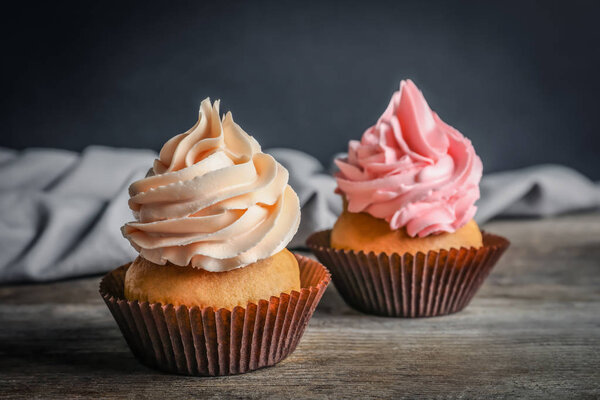 Yummy cupcakes on wooden table 