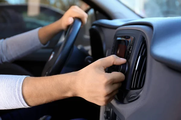 Man tuning car radio — Stock Photo, Image