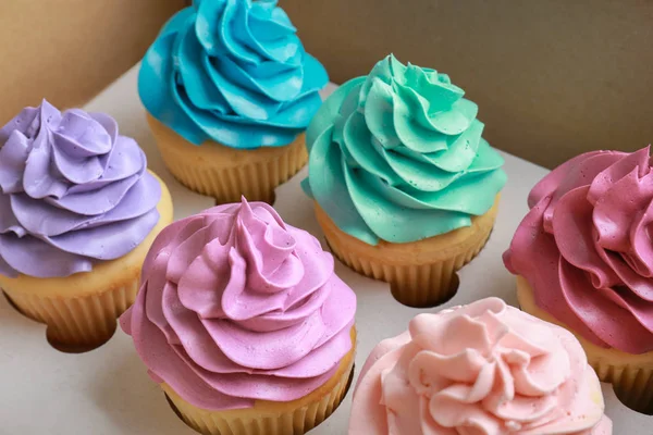 Tasty colorful cupcakes in cardboard box — Stock Photo, Image