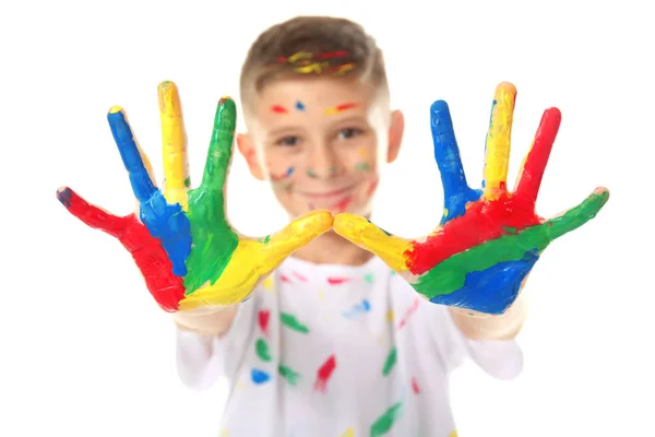 Cute little boy with hands and face in paint on white background — Stock Photo, Image
