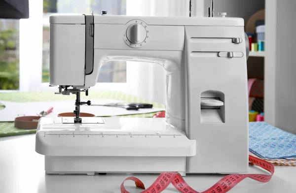 Modern sewing machine on table — Stock Photo, Image