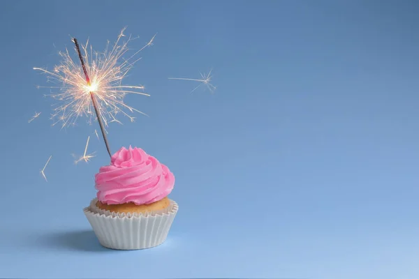 Yummy cupcake with sparkler — Stock Photo, Image