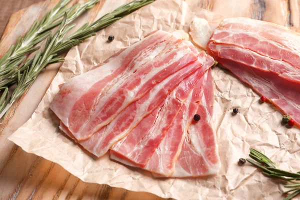 Rashers of bacon on wooden board — Stock Photo, Image