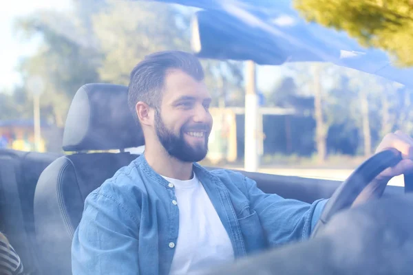 Happy young man driving a car, view through windshield — Stock Photo, Image