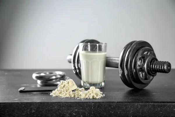 protein powder and dumbbell