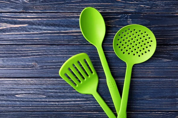 Various kitchen utensils on wooden background — Stock Photo, Image