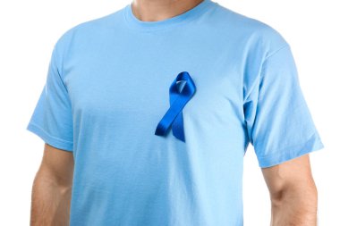 Young man in t-shirt with symbolic blue ribbon on white background. Cancer awareness concept clipart