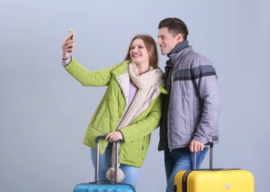 Happy tourists with suitcases clipart