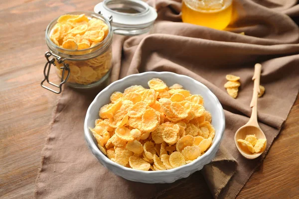 Composition with tasty cornflakes on wooden background — Stock Photo, Image