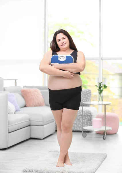 Mujer con sobrepeso sosteniendo escamas —  Fotos de Stock
