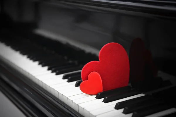 Red hearts on piano keys