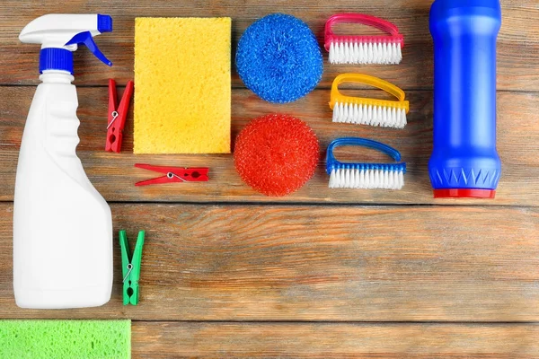 Cleaning supplies on wooden background — Stock Photo, Image