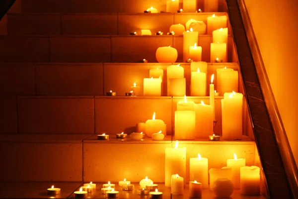 Burning candles on stairs — Stock Photo, Image