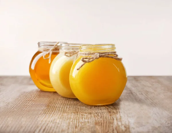 Aromatic honey in glass jars — Stock Photo, Image