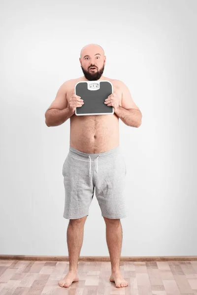 Overweight man holding scales — Stock Photo, Image