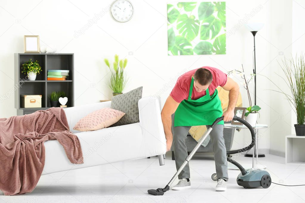 Young man cleaning floor 