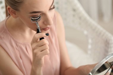 Kirpik bigudisi kullanan kadın 