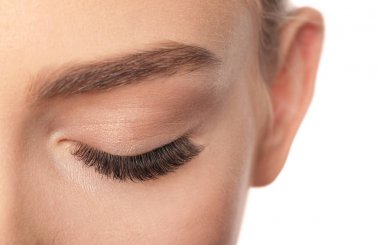 Kapalı gözler ve beyaz arka planda, closeup uzun kirpiklerini kadın ile