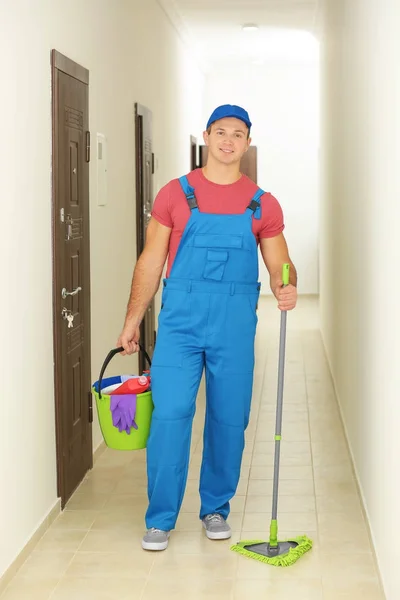 Young man with cleaning supplies — Stock Photo, Image