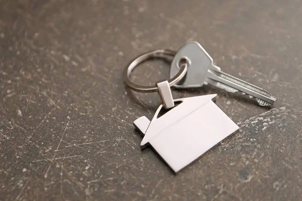 Key with trinket in shape of house — Stock Photo, Image
