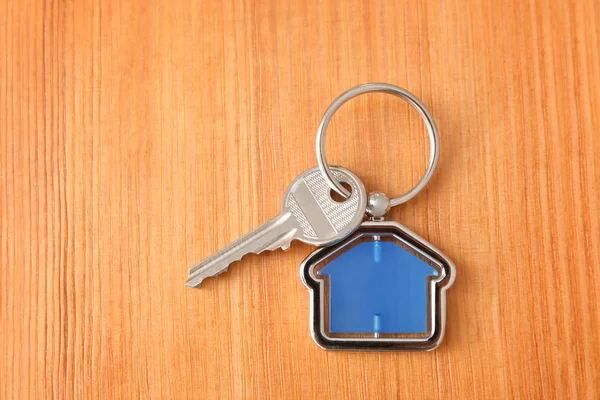 Key with trinket in shape of house — Stock Photo, Image