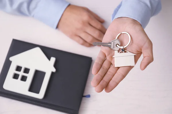 Real estate agent with key — Stock Photo, Image