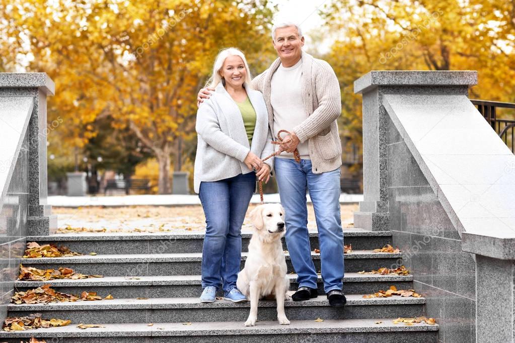 Mature couple with dog in park