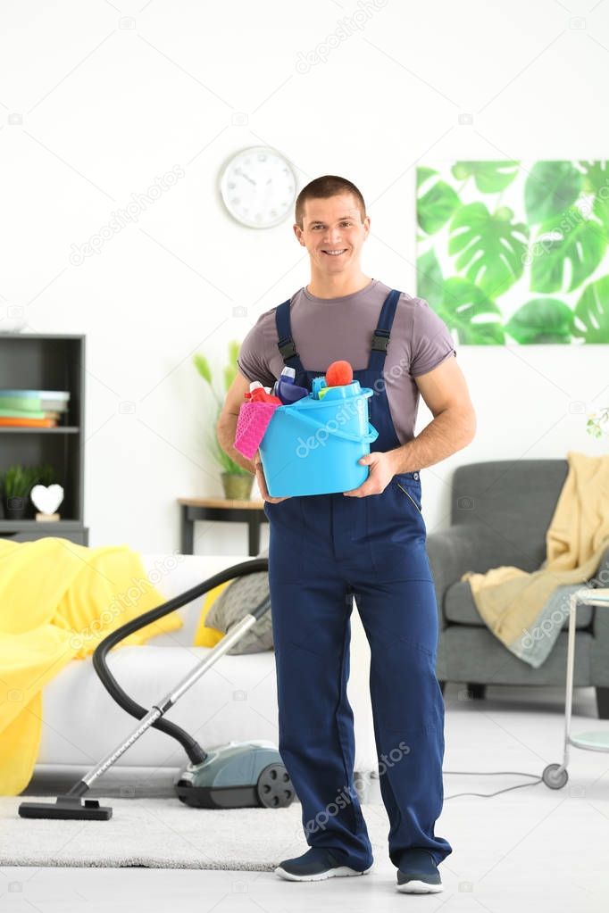 Young man with cleaning supplies 