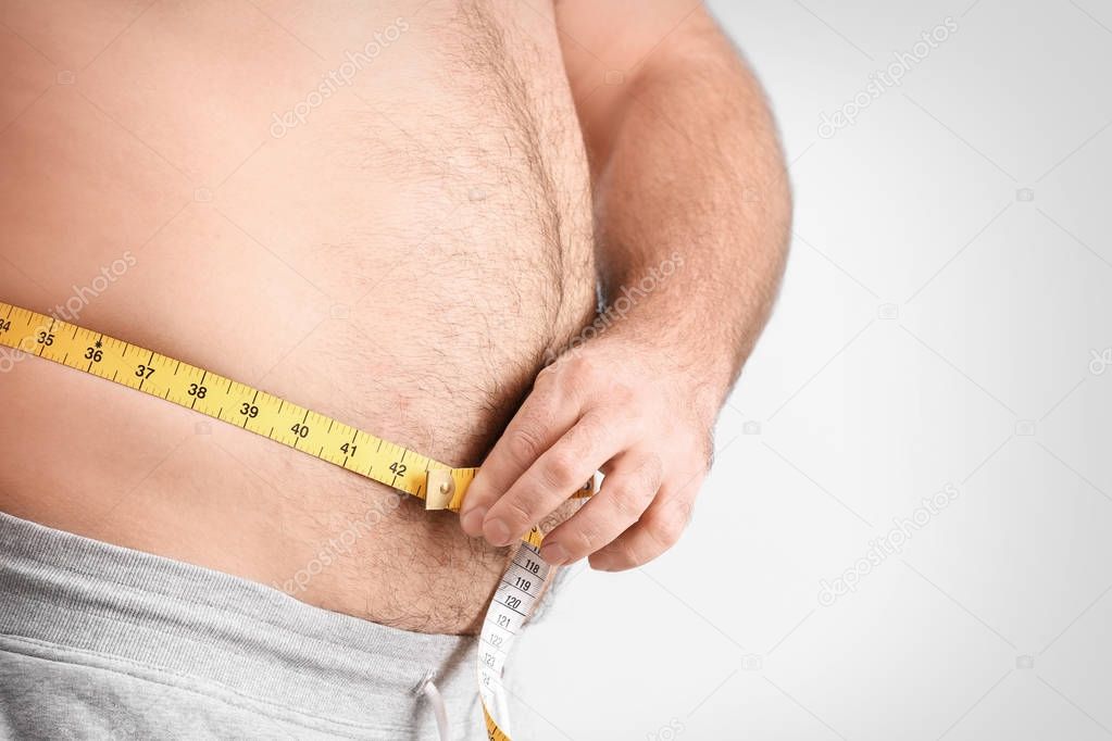 Overweight man with measuring tape