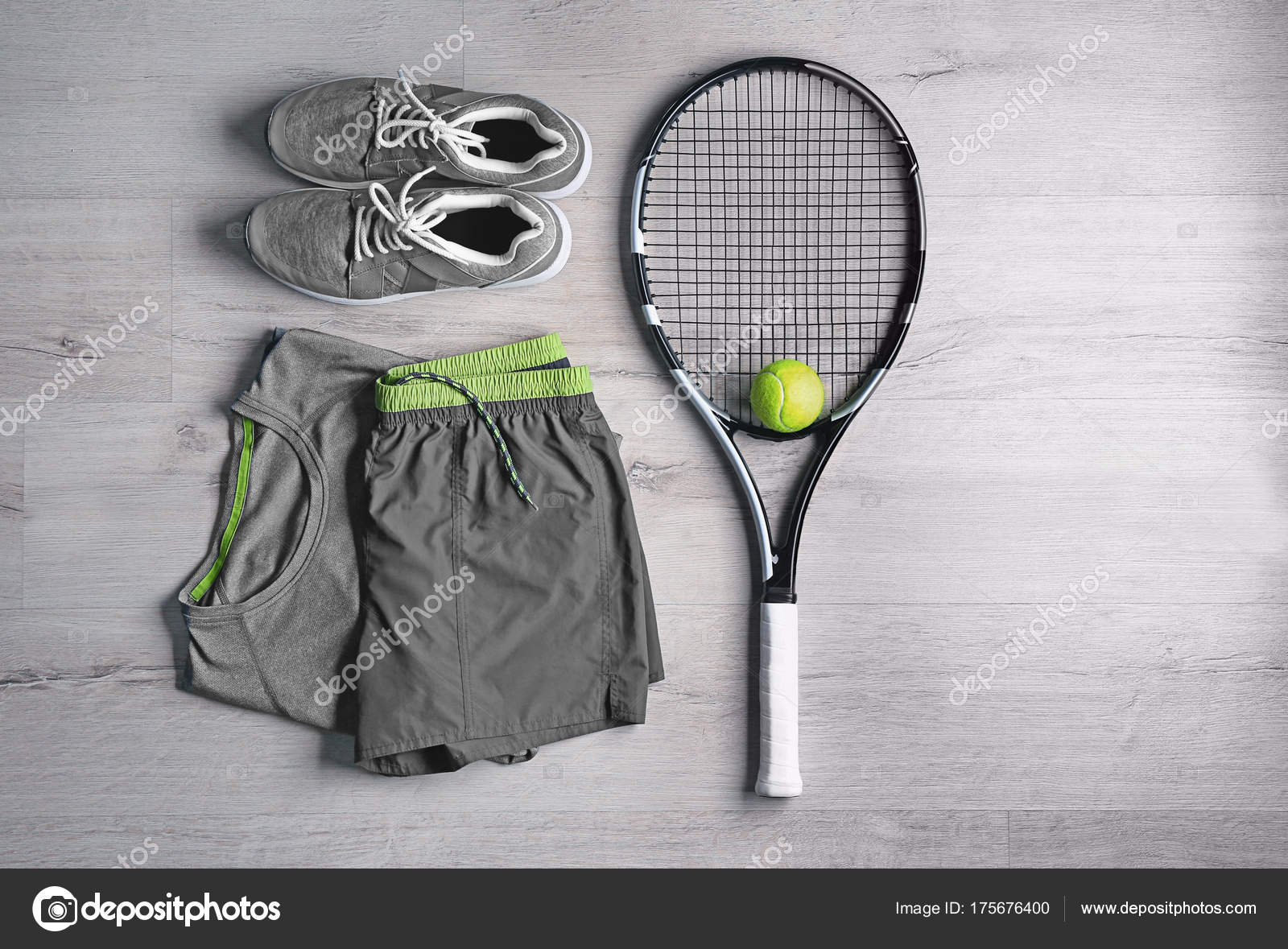 Tennis racket, ball, clothes and shoes on wooden background Stock Photo by ©belchonock 175676400