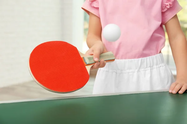 Cute little girl playing table tennis indoors — Stock Photo, Image