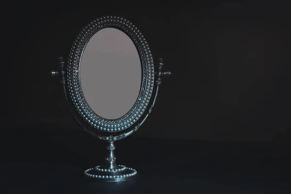 Vintage small mirror on black background — Stock Photo, Image