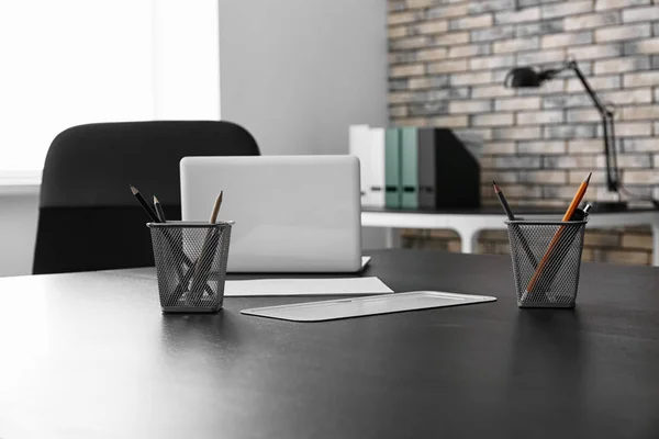 Big table with laptop and stationery, indoors — Stock Photo, Image