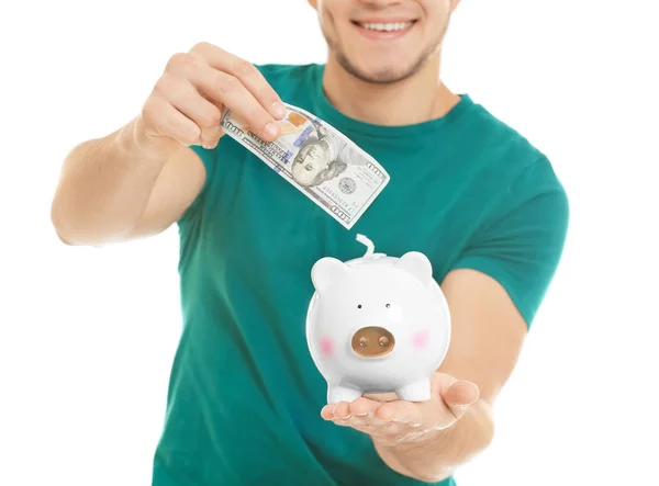 Šťastný Mladý Muž Uvádění Bankovek Prasátko Bílém Pozadí — Stock fotografie