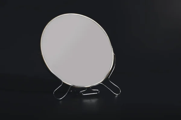 Small mirror on black background — Stock Photo, Image