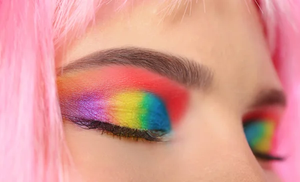 Young woman with rainbow eye makeup