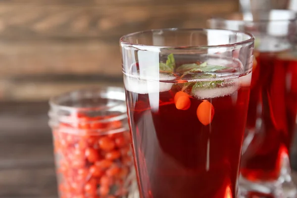 Glass with healthy goji juice on table — Stock Photo, Image