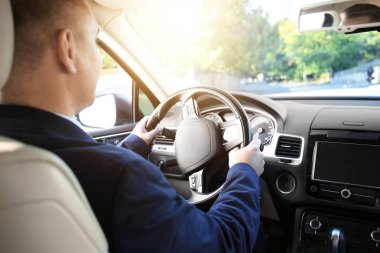 Adam arabanın sürücü koltuğuna üzerinde formal giyim