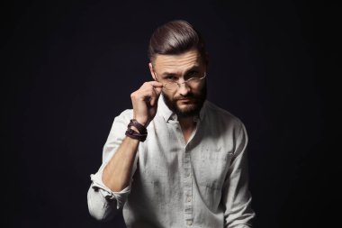 Yakışıklı genç hipster adam siyah arka plan üzerine portresi