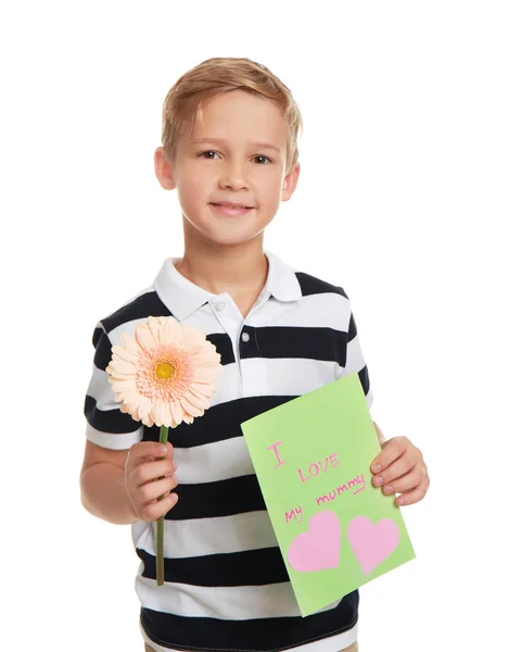 Niedlicher kleiner Junge mit Blume und Grußkarte zum Muttertag auf weißem Hintergrund — Stockfoto