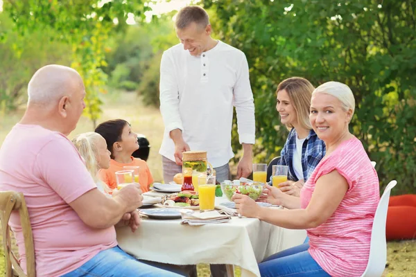 Happy family having barbecue party outdoors — Stock Photo, Image