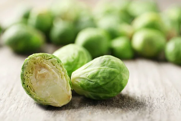 Raw Brussels sprouts on wooden table, closeup — Stock Photo, Image