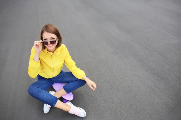 Hipster fille avec planche à roulettes en plein air — Photo