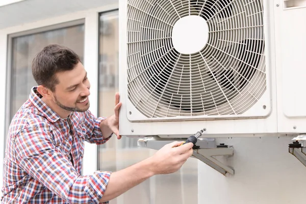 Homme réparant climatiseur — Photo