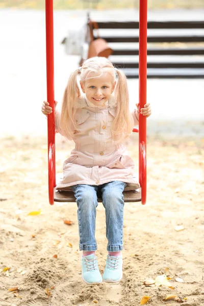 Cute Little Girl Outwear Swinging Outdoors — Stock Photo, Image