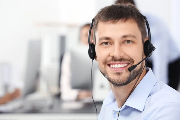 Male consulting manager with headset in office